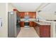 Well-lit kitchen features stainless steel appliances, granite countertops and generous cabinet space at 6059 Twain St # 108, Orlando, FL 32835