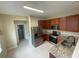 Well-lit kitchen with stainless steel appliances, dark cabinets, and a breakfast bar at 6059 Twain St # 108, Orlando, FL 32835
