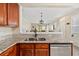 Open concept kitchen with granite countertops, stainless steel appliances and views to the living area at 6059 Twain St # 108, Orlando, FL 32835