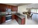 Kitchen with stainless steel appliances, granite countertops, and an open view of the dining area at 6059 Twain St # 108, Orlando, FL 32835
