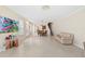 Open-concept living room with tile flooring, natural light, and neutral paint at 6059 Twain St # 108, Orlando, FL 32835