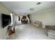 Open-concept living area with neutral tones and tile flooring offers versatile layout options at 6059 Twain St # 108, Orlando, FL 32835