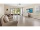 Bright living room features tile floors, neutral paint, and sliding glass doors to the screened in lanai at 6059 Twain St # 108, Orlando, FL 32835