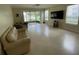 Bright living room features tile floors, neutral paint, and sliding glass doors to the screened in lanai at 6059 Twain St # 108, Orlando, FL 32835
