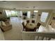 Open-concept living area features tile floors, a modern light fixture, and views of the backyard at 6059 Twain St # 108, Orlando, FL 32835