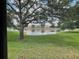 Scenic view of pond and lush landscaping at 6059 Twain St # 108, Orlando, FL 32835