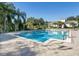 Community pool with palm trees and a clubhouse, great for relaxing and socializing at 6059 Twain St # 108, Orlando, FL 32835