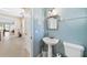 Half bathroom with pedestal sink and decorative mirror at 6059 Twain St # 108, Orlando, FL 32835