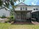 Screened patio in the backyard, framed by landscaping, grassy area and the exterior of the home at 6059 Twain St # 108, Orlando, FL 32835