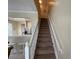 A staircase leads to the upper level, complemented by neutral tones and natural light at 6059 Twain St # 108, Orlando, FL 32835