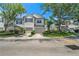 Exterior of a two-story townhome featuring attached garages and manicured landscaping in a desirable community at 6059 Twain St # 108, Orlando, FL 32835
