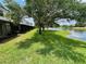 Scenic water view from the backyard, complemented by lush greenery and screened in patios at 6059 Twain St # 108, Orlando, FL 32835