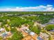 Beautiful aerial view of a lush neighborhood with mature trees, diverse homes, and a nearby school at 70 N Oak Ave, Umatilla, FL 32784