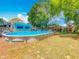 Spacious backyard featuring an above-ground pool, a patio area, and plenty of room for outdoor activities at 70 N Oak Ave, Umatilla, FL 32784