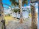 A well-maintained shed sits in a charming backyard area, surrounded by lush greenery and a wooden fence at 70 N Oak Ave, Umatilla, FL 32784