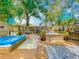 Expansive backyard features a large deck, hot tub, outdoor seating, and lush landscaping at 70 N Oak Ave, Umatilla, FL 32784