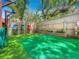 Well-maintained backyard with artificial turf, colorful seating, and a quaint garden area at 70 N Oak Ave, Umatilla, FL 32784