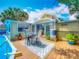 Charming backyard with a pool, wooden deck, patio table, and lush greenery, perfect for relaxing at 70 N Oak Ave, Umatilla, FL 32784