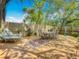 Beautiful backyard features an expansive wooden deck with lounge chairs and dining table at 70 N Oak Ave, Umatilla, FL 32784