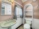 This full bathroom features a sink and toilet combo at 70 N Oak Ave, Umatilla, FL 32784