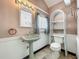 This full bathroom features a vintage sink and toilet combo at 70 N Oak Ave, Umatilla, FL 32784