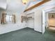 This bedroom features a window, and closet with view of hallway and stairway at 70 N Oak Ave, Umatilla, FL 32784