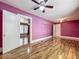 A bedroom view featuring hardwood floors, ceiling fan, and natural light at 70 N Oak Ave, Umatilla, FL 32784