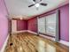 A bedroom view featuring hardwood floors, ceiling fan, and natural light at 70 N Oak Ave, Umatilla, FL 32784