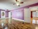 A bedroom view featuring hardwood floors, ceiling fan, and natural light at 70 N Oak Ave, Umatilla, FL 32784