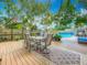 Expansive wooden deck featuring a dining area, a swimming pool, and plenty of room for entertaining at 70 N Oak Ave, Umatilla, FL 32784