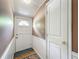 Entryway features a white door, paneled walls, and wood flooring at 70 N Oak Ave, Umatilla, FL 32784