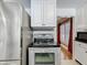 A kitchen view featuring a stainless steel refrigerator, oven, and white cabinets at 70 N Oak Ave, Umatilla, FL 32784