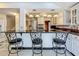 Kitchen island bar with seating, view of the kitchen appliances, and decorated cabinets at 70 N Oak Ave, Umatilla, FL 32784