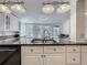 Spacious kitchen with stainless steel sink, granite countertops and views to the backyard at 70 N Oak Ave, Umatilla, FL 32784