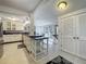 Open kitchen with an island, tiled floors and a view to the backyard through sliding glass doors at 70 N Oak Ave, Umatilla, FL 32784