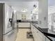 A kitchen view featuring a stainless steel refrigerator, countertop, and white cabinets at 70 N Oak Ave, Umatilla, FL 32784