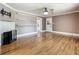 Bright living room with hardwood floors, fireplace and view to entry hall at 70 N Oak Ave, Umatilla, FL 32784