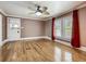 Living room with hardwood floors, natural light and a decorated entry door at 70 N Oak Ave, Umatilla, FL 32784