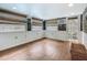 Bright sun room features wood-look floors, recessed lighting, large windows with wood blinds, and convenient access to the backyard at 70 N Oak Ave, Umatilla, FL 32784