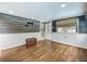 Charming sun room with wood-look floors, neutral walls, backyard access, and lots of natural light at 70 N Oak Ave, Umatilla, FL 32784