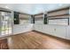 Beautiful sun room offers wood-look floors, recessed lighting, three large windows with blinds, and backyard access at 70 N Oak Ave, Umatilla, FL 32784