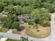 Aerial view of house with lush trees, a large yard, mature landscaping, and a private setting at 994 Country Lake Cir, Lake Wales, FL 33898