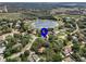 Stunning aerial view of the neighborhood, highlighting lush landscaping, nearby lake, and community at 994 Country Lake Cir, Lake Wales, FL 33898