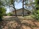Large backyard with mature trees and ample space for outdoor activities, a great place for relaxing at 994 Country Lake Cir, Lake Wales, FL 33898