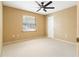 Bright bedroom features neutral paint, carpet and a ceiling fan at 994 Country Lake Cir, Lake Wales, FL 33898