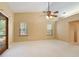 Open living room with vaulted ceiling, ceiling fan and outdoor access at 994 Country Lake Cir, Lake Wales, FL 33898