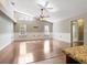 Bright living room featuring a vaulted ceiling, hardwood floors, and large windows at 994 Country Lake Cir, Lake Wales, FL 33898