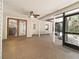 Large covered patio featuring tiled flooring, ceiling fans and access to the yard at 994 Country Lake Cir, Lake Wales, FL 33898