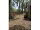 Serene backyard features mature trees, seating, and a brick wall, creating a peaceful outdoor space at 1608 Fox Glen Ct, Winter Springs, FL 32708