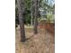 Tranquil backyard featuring mature trees, bench seating, and a brick wall creating a private outdoor space at 1608 Fox Glen Ct, Winter Springs, FL 32708